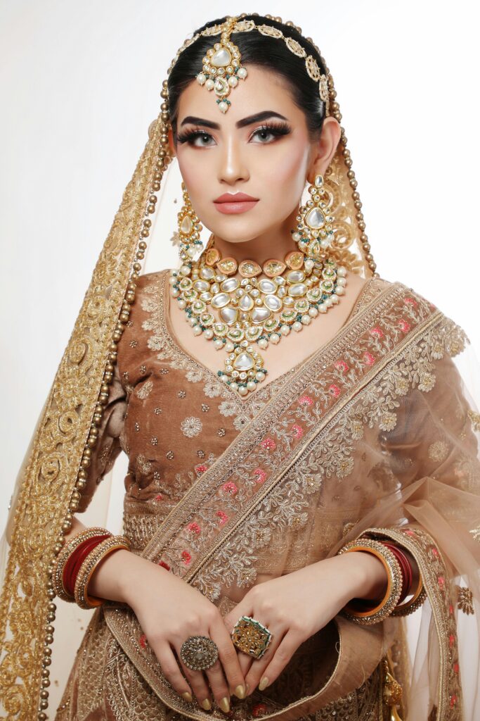 Portrait of a South Asian bride showcasing luxurious traditional attire and jewelry.